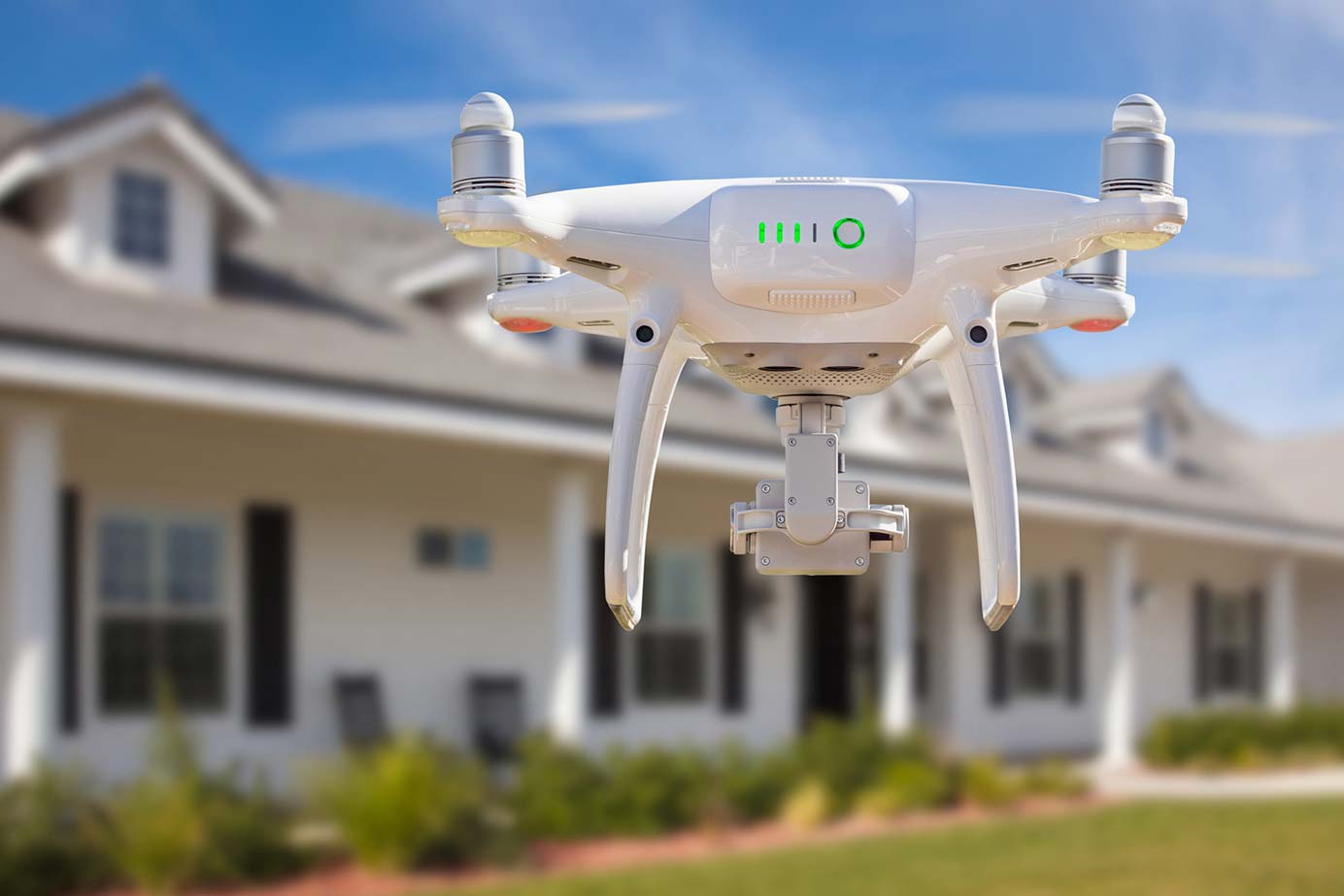 Aerial drone flying over a house while preforming home inspection services