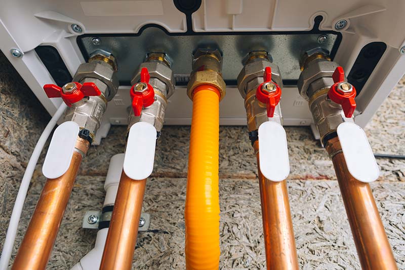 modern gas boiler piping seen while preforming a home inspection